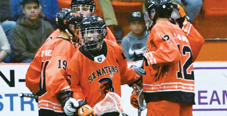 Six Nations Rebels’ captain Chaz Hill (centre of pic with stick) celebrates his goal in the club’s season opener this past Friday. Photo courtesy Six Nations Rebels.