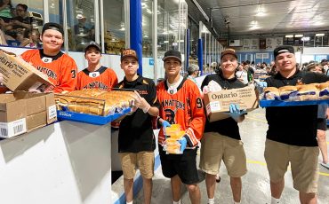 Six Nations Lacrosse Rebels youth team came to volunteer at this year’s Bread and Cheese armed with smiles and bread and cheese. (Photo by Alex Murray)