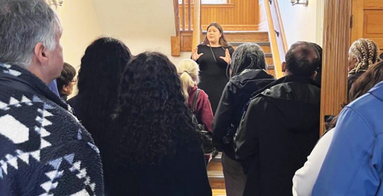 Sam Hill, left, and the BIPOC committee hear the history of the building they are touring along with Sam Hill’s mother who attended as a student.