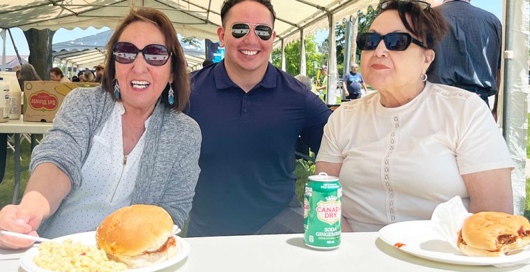 Six Nations band councillors Cynthia Jamieson, Dean Hill and Hazel Johnson took a minute to enjoy the SNEC barbecue after serving up pulled pork sandwiches for the crowd.. (Photos by Alex Murray)