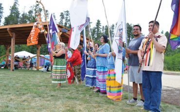 The Mattagami FN 12th Annual Pow Wow was held on August 15 and 16, 2026. Pictured is Chief Jennifer Constant, Mattagami FN (in the green dress) leading the flag bearers for the opening of the first day of the Pow Wow on Saturday August 15. (Photo by X Kataquapit)