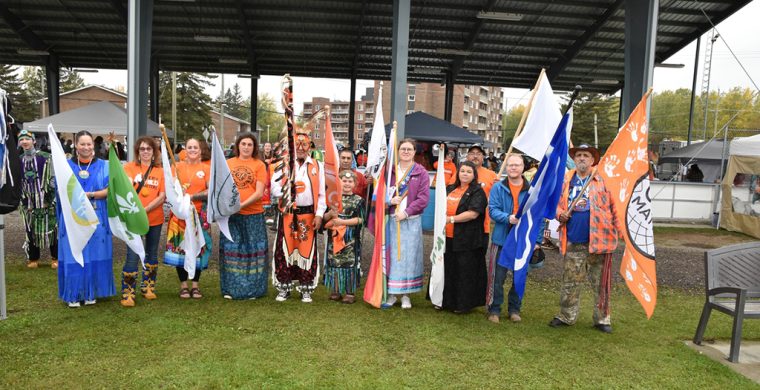 The flag bearers for the grand entry and exit of the Sixth Annual Every Child Matters Pow Wow in Kirkland Lake were from L-R: Sue Alton, Mino M’shki-ki Health Team; Rox-Anne Gaignard, Centre de santé communautaire du Témiskaming; Lori Lalonde, Keepers of the Circle; Marie Claude Patry, EarlyON; Elder George Rose Paulmartin, Head Elder Dancer; Dawson Moore (in front), Every Child Matters flag; Councillor Real Boucher, Matachewan FN; Alexie Polson, Two-Spirit flag; Mayor Stacy Wight, Town of Kirkland Lake; Chief Wayne Wabie, Beaverhouse FN; Tyler Twarowski, Metis Nation of Ontario and Michel Dupuis, representing Veterans flag. (Photo by Xavier Kataquapit)